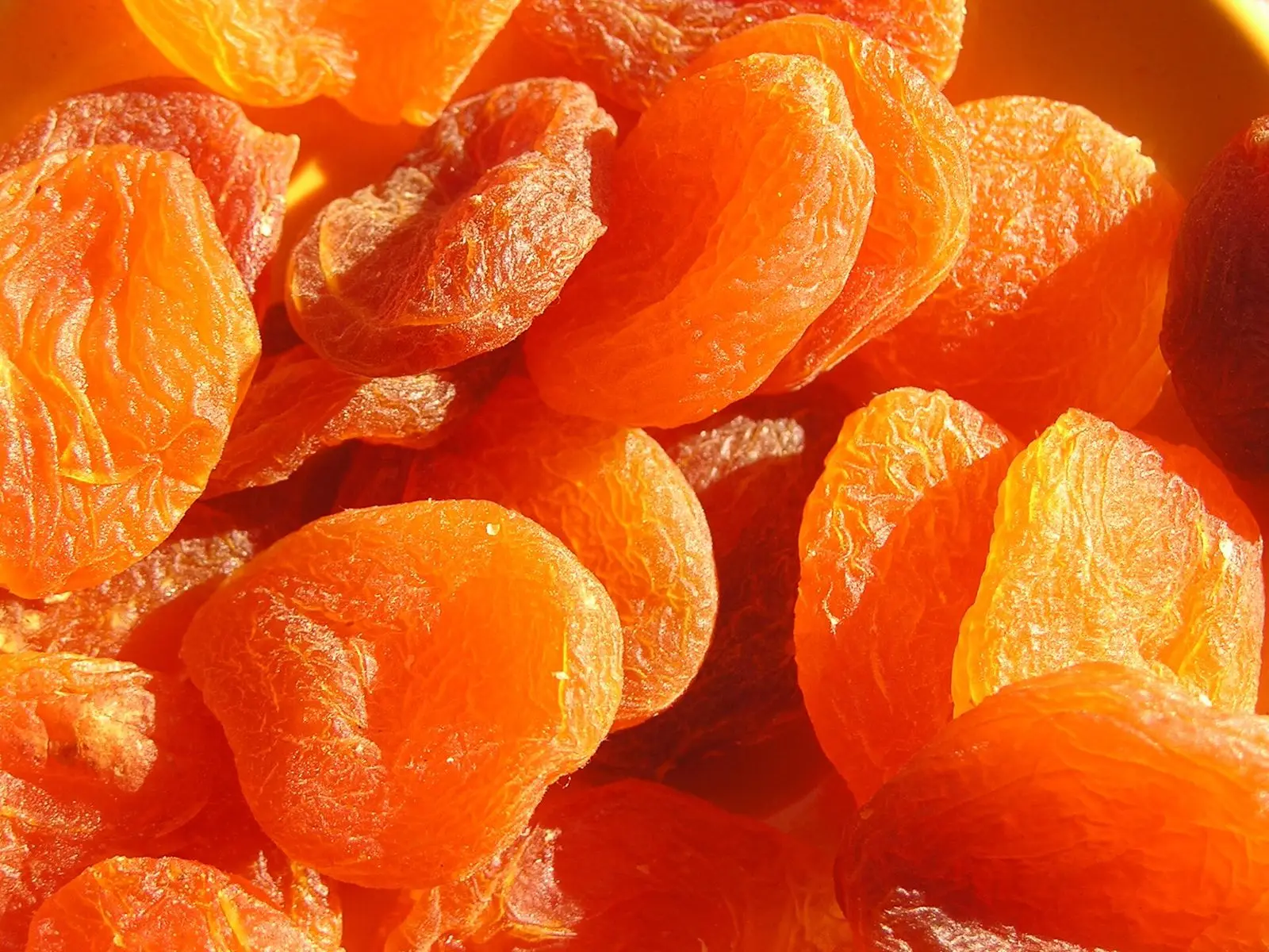 Bright orange dried apricot halves piled together