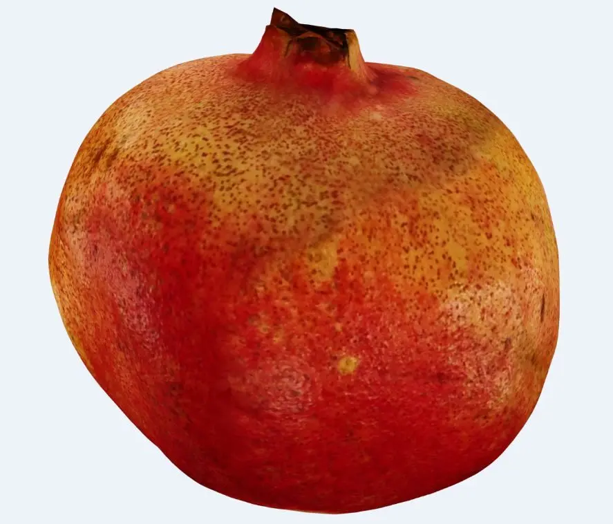 A whole pomegranate with deep red skin and a crowned calyx